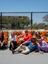 注册商 staff sitting in front of Pitzer flower sign